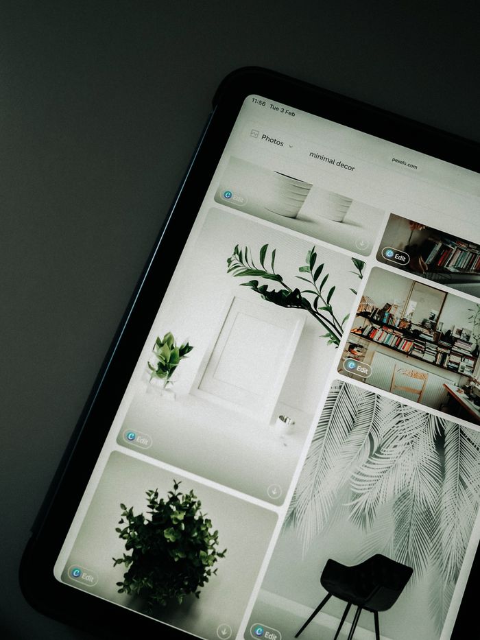 our-story A tablet screen featuring images of minimalist decor emphasizing greenery and simple design.